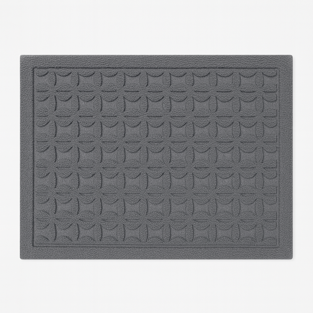 Rechthoekige deurmat met reliëf geometrisch patroon.